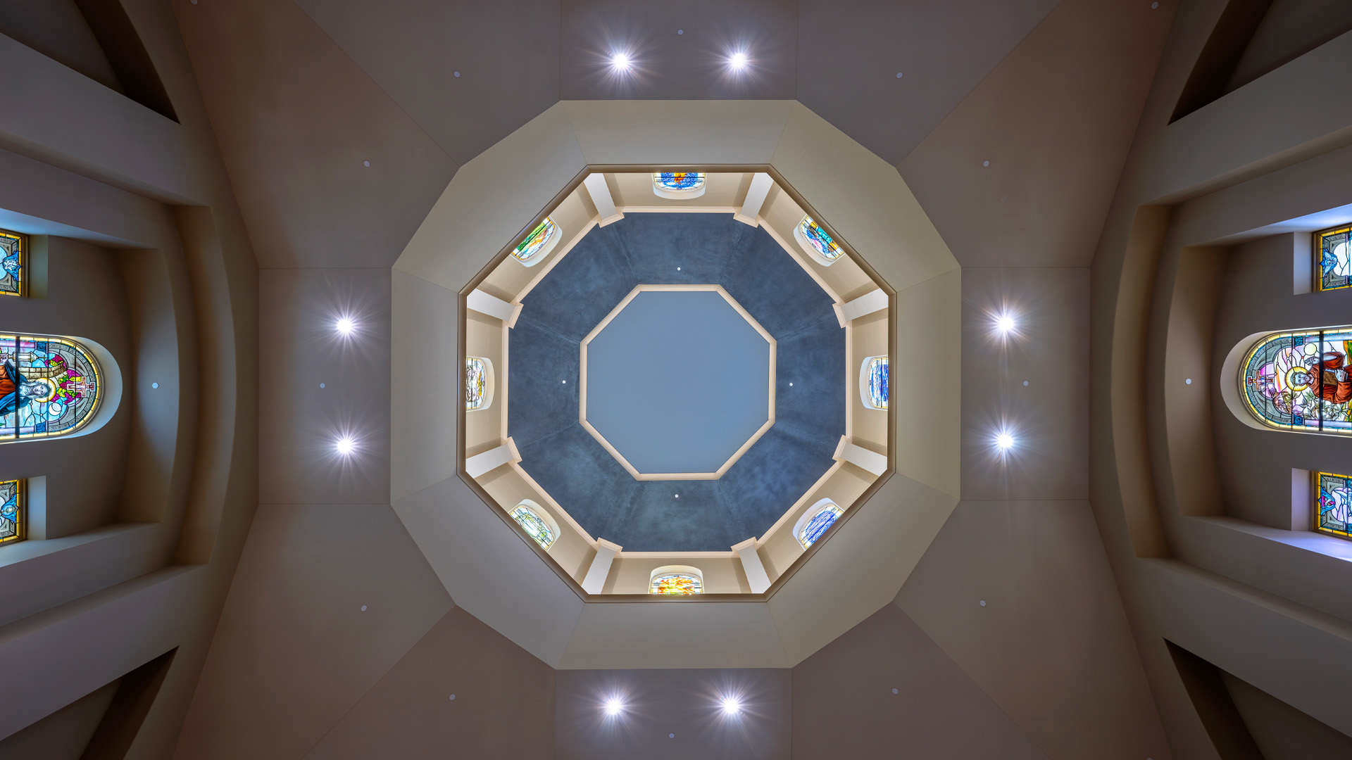 Detailed interior ceiling at the University of Saint Francis Chapel of St Francis of Assisi with stained glass.