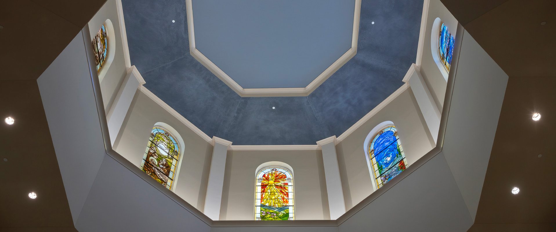 Traditional chapel stained glass ceiling detailing in the University of Saint Francis Chapel of Assisi.