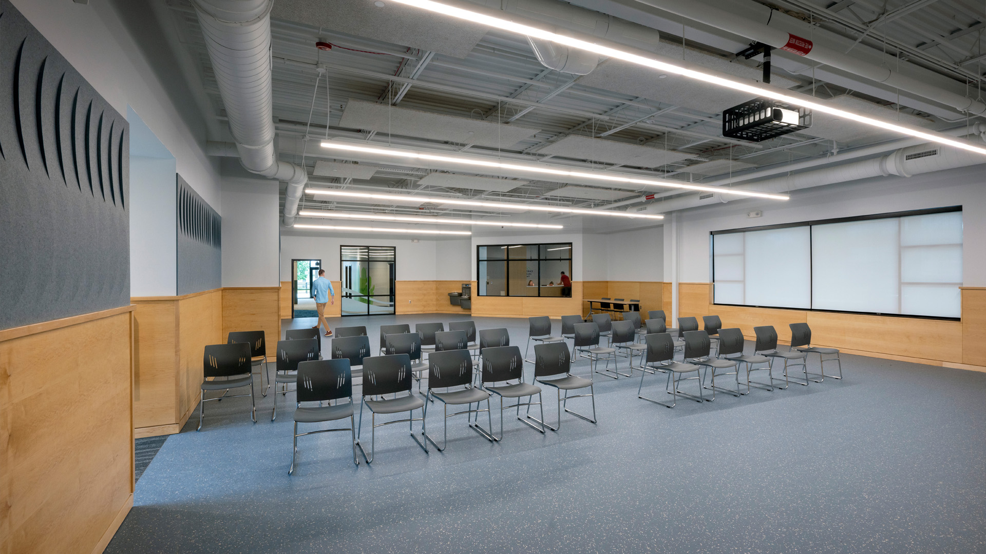 Flexible event meeting space with chairs and screen.