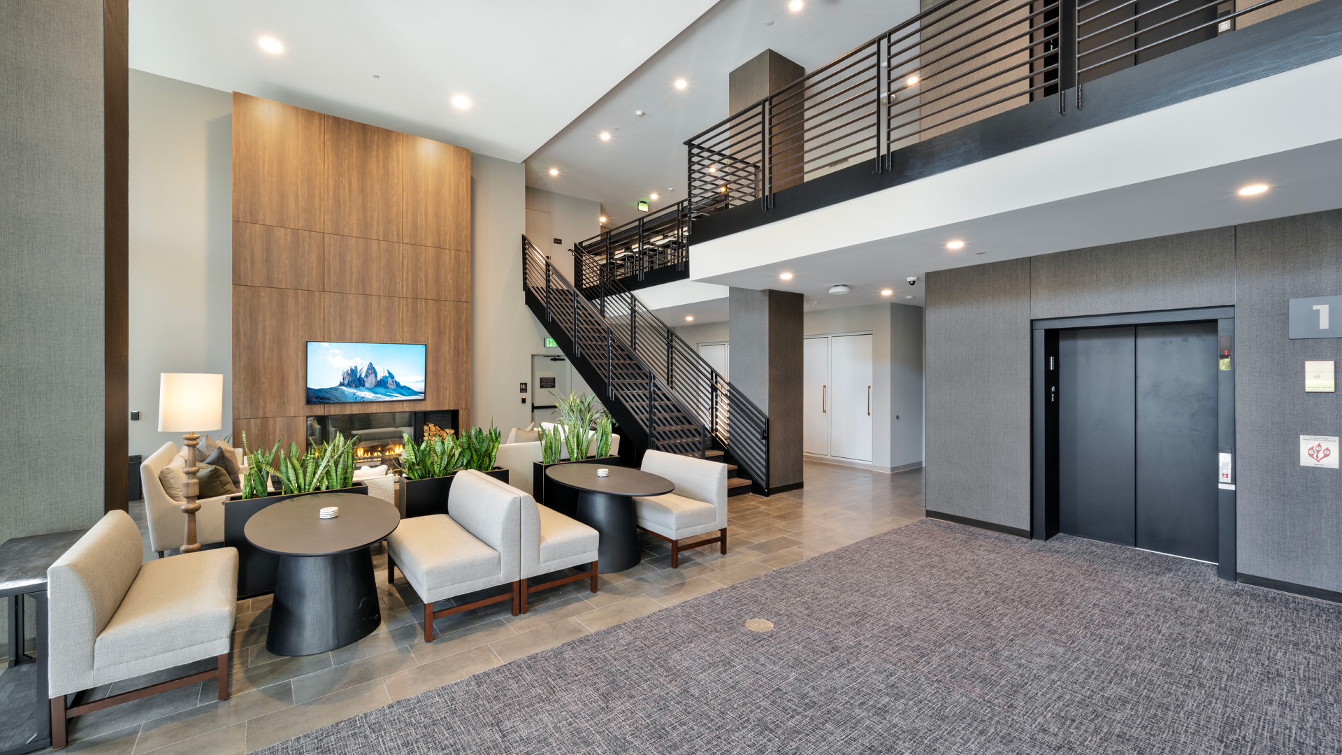 Luxury apartment lobby with couches and concierge.