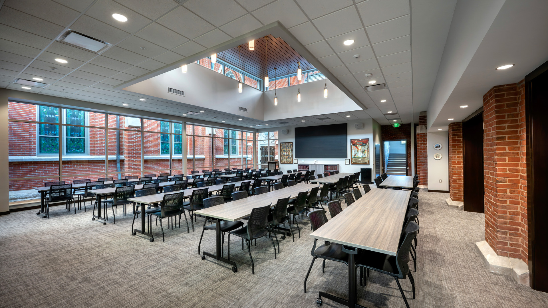 Conference room at St. Pauls Lutheran Church Heritage Hall with large windows warm brick, and skylight ceiling.