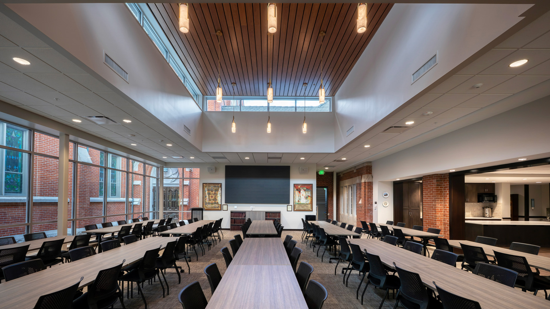 Conference room at St. Pauls Lutheran Church Heritage Hall with large windows warm brick, and skylight ceiling.