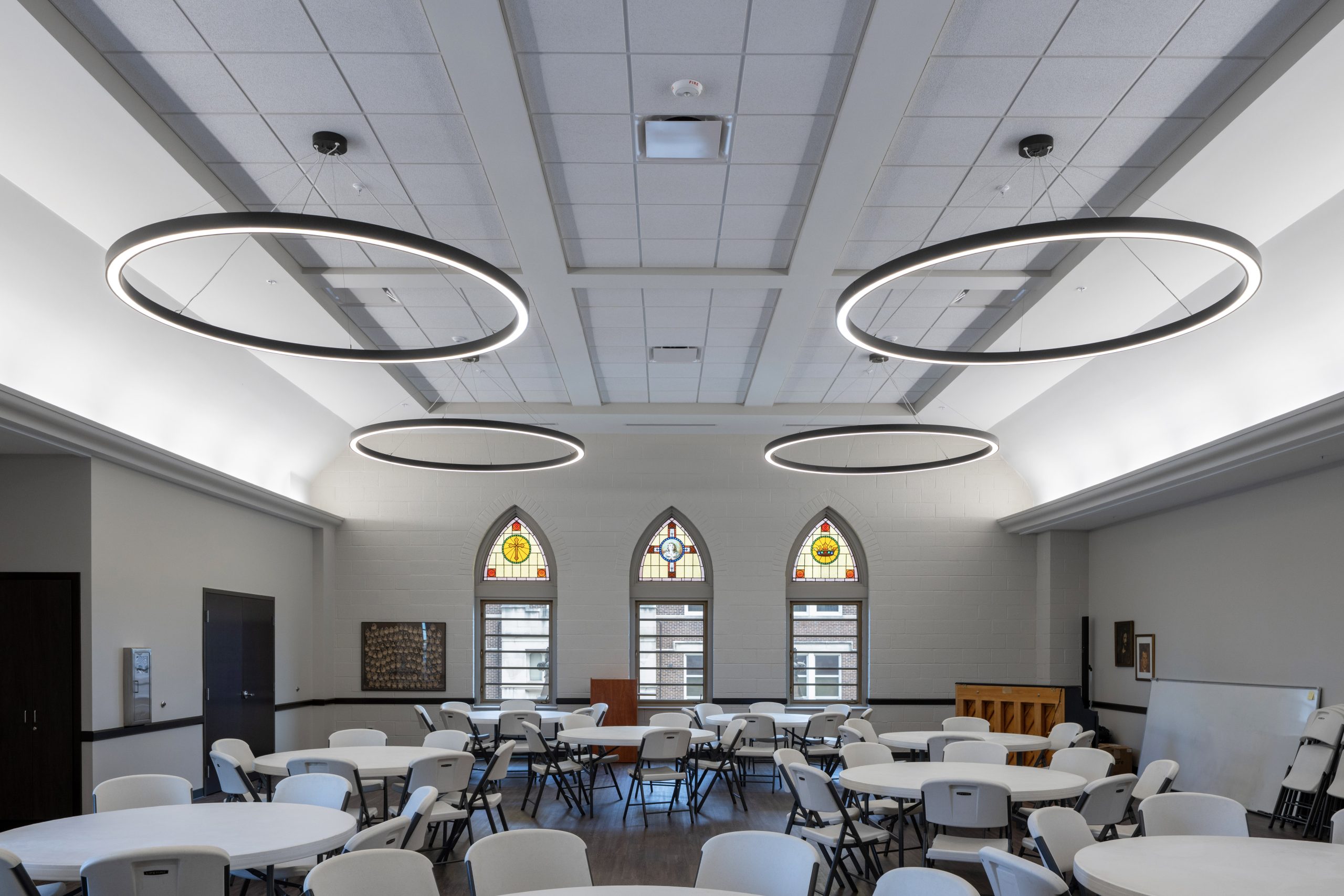 Banquet hall with preserved stained glass windows.