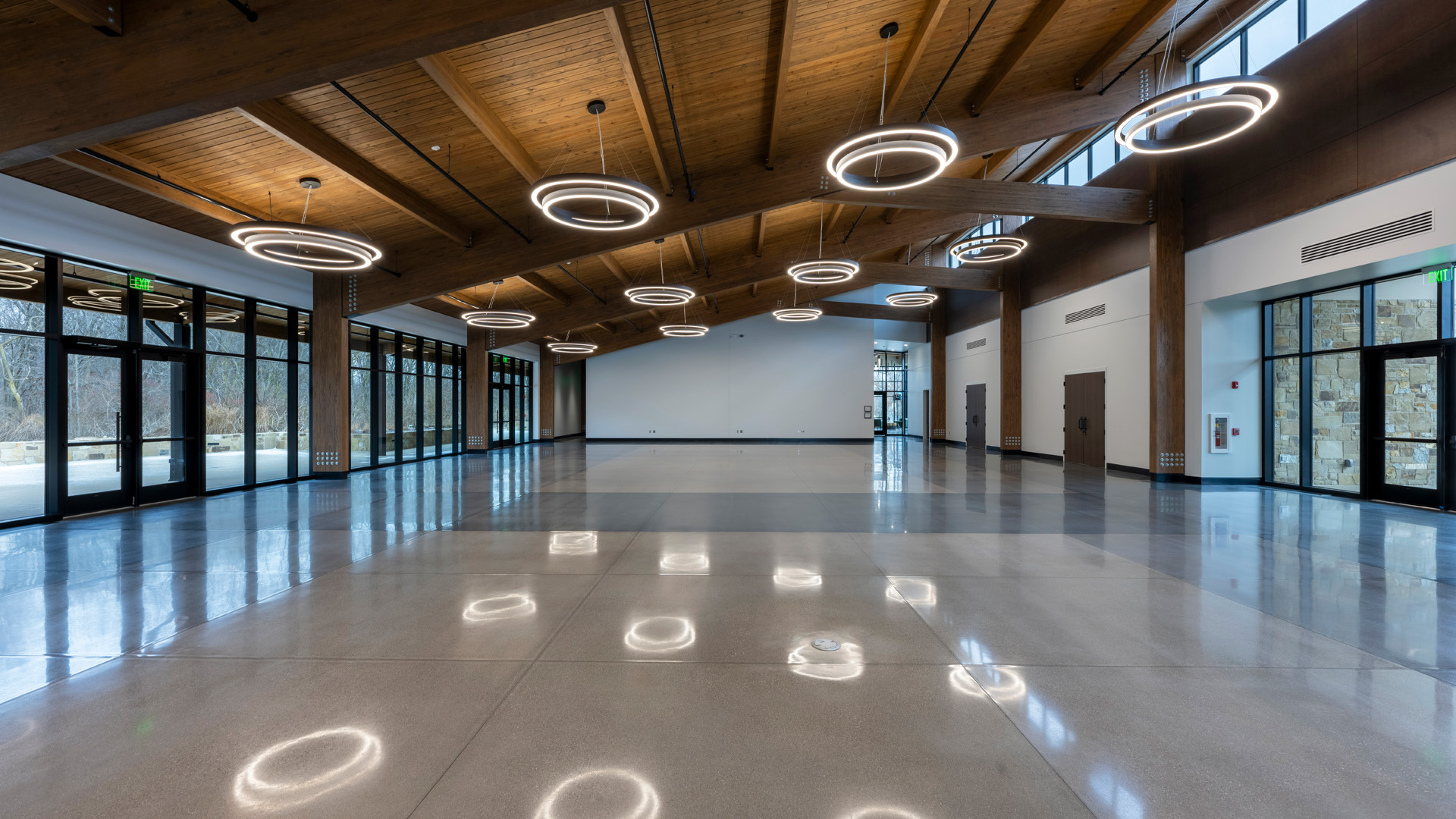 Event space with warm wood ceiling and circular lighting details.