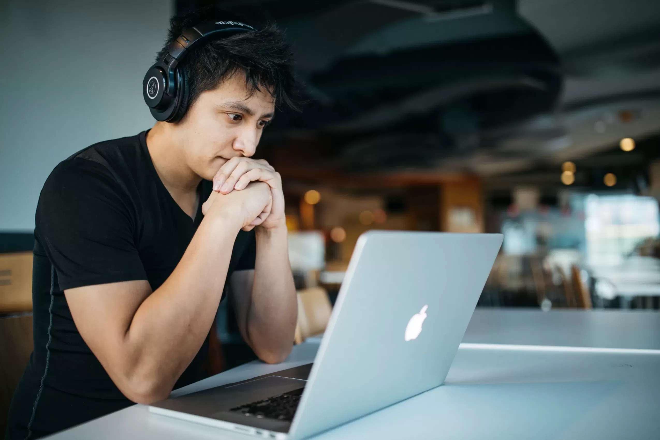 Student Wearing Headphones Staring at Laptop