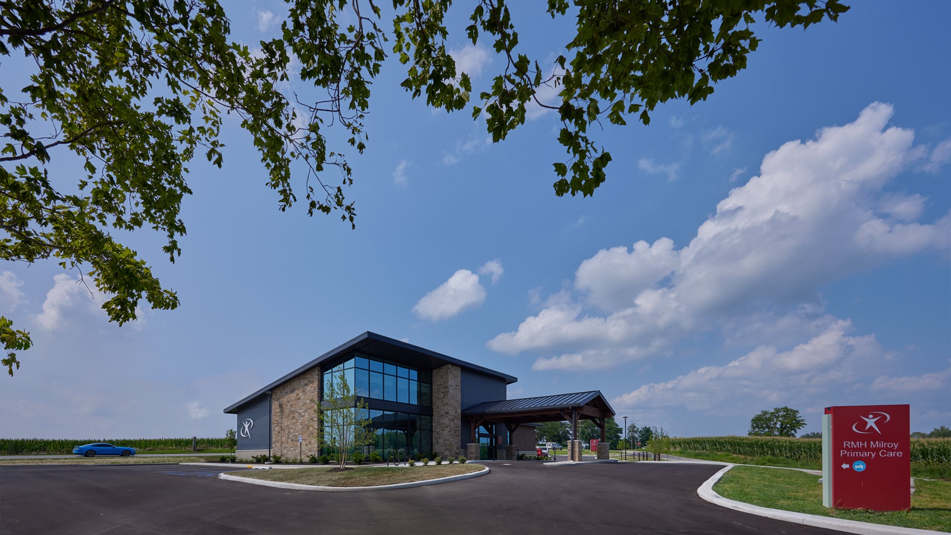 Rush Memorial Milroy Clinic building with large windows reflecting the blue sky.
