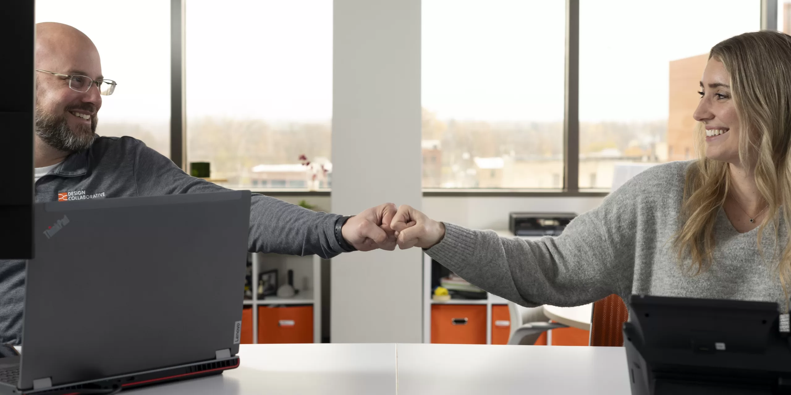 Two architects give fist bump