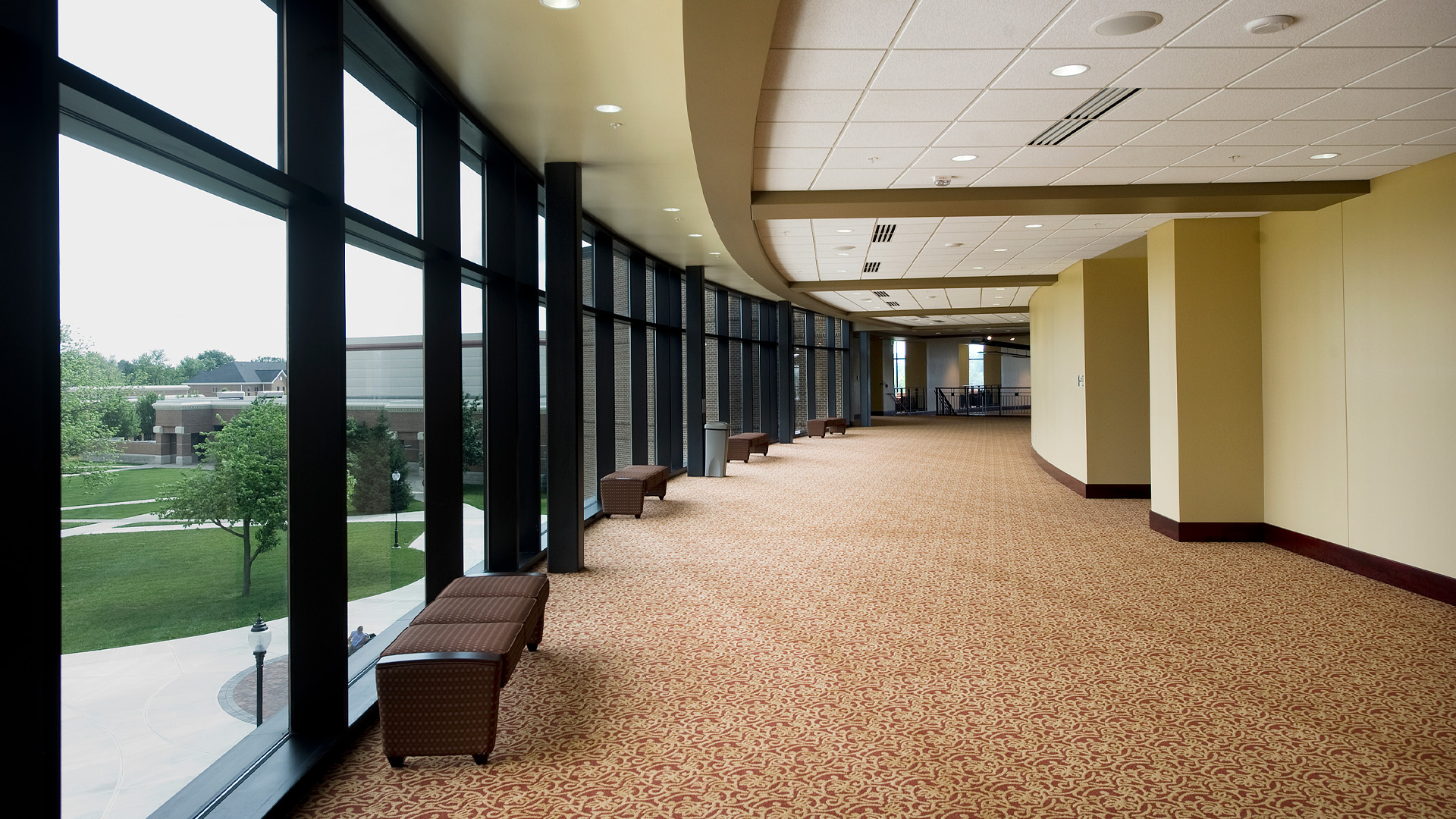 Indiana Wesleyan University Chapel Auditorium curved hallway with large windows.