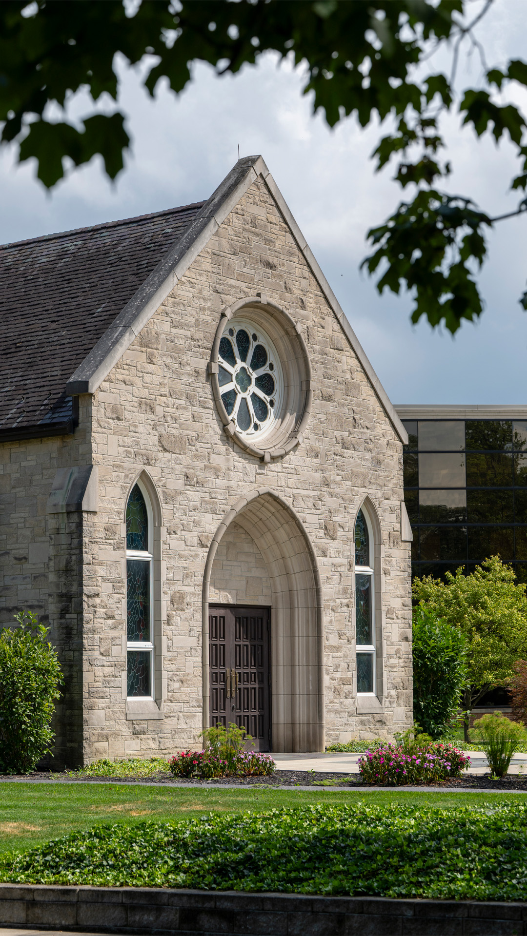 Indiana Wesleyan University Prayer Chapel Building made of stone with a steeple and stained glass windows.