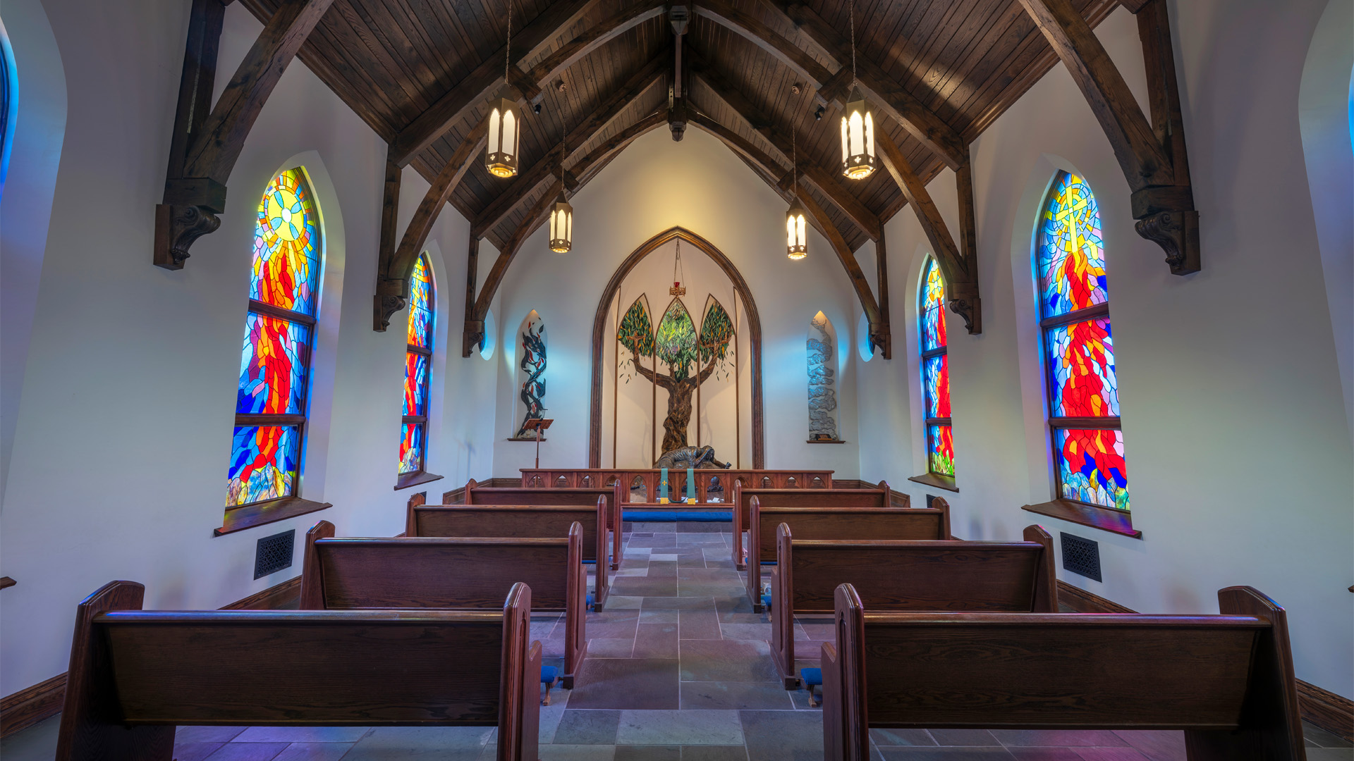 Indiana Wesleyan University Prayer Chapel Building interior with stained glass windows and rows of pews.