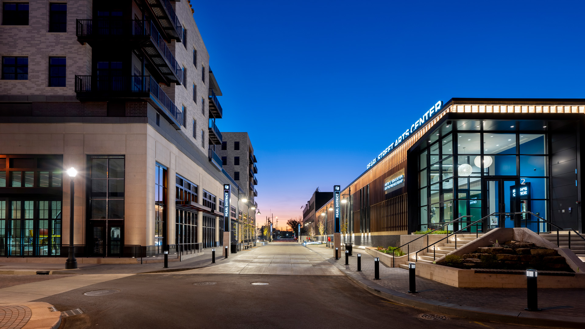 Pearl Arts Exterior at dusk with lit streetscape.