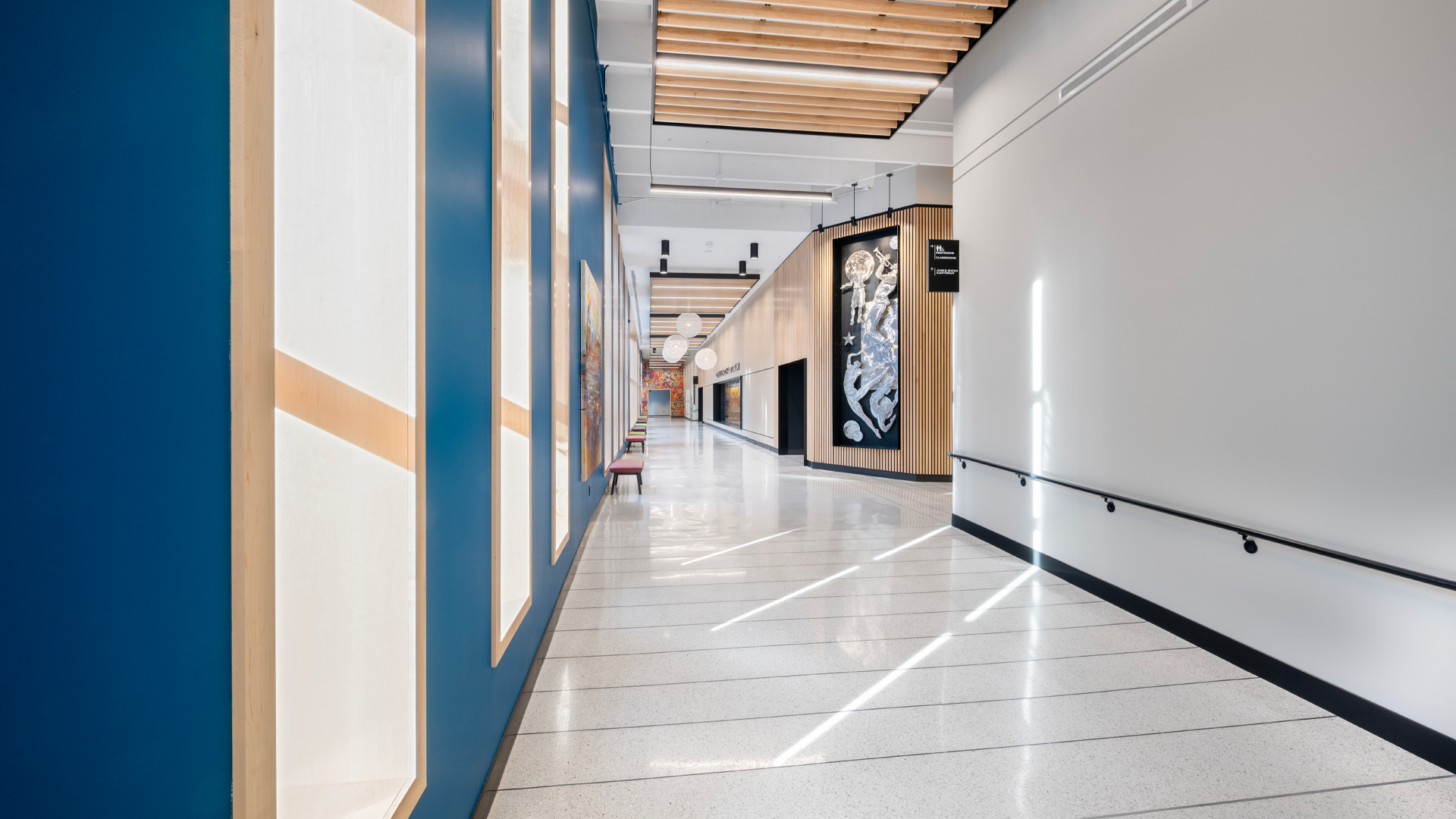 Bright blue hallway with large windows.