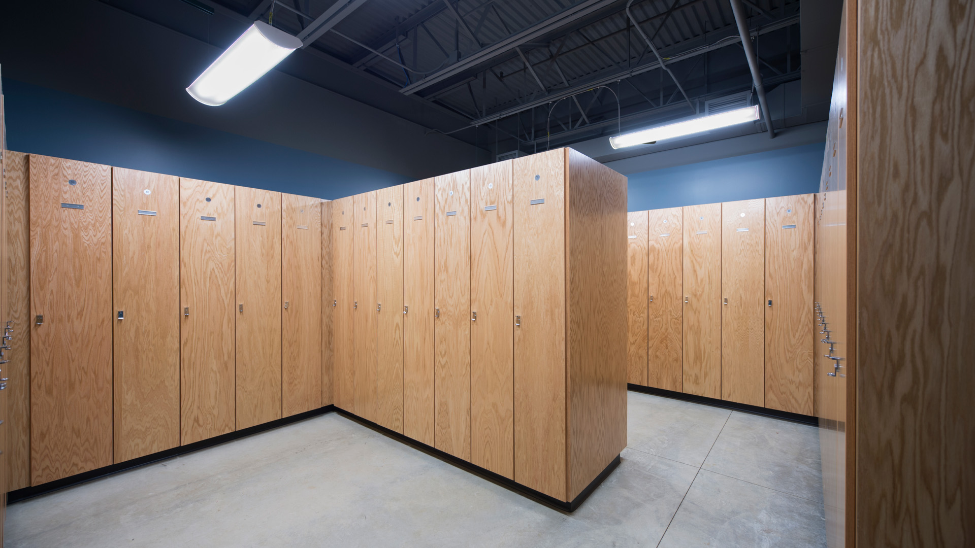 Hillsdale College - Biermann Athletic Center locker room with blue walls.