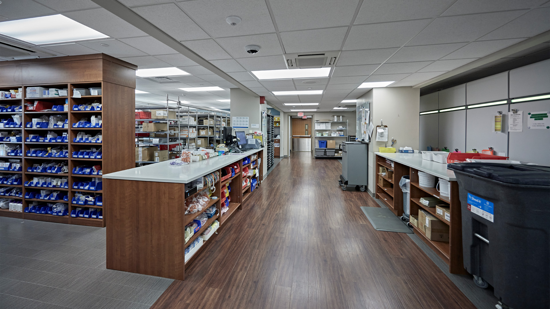 Pharmacy storage room with long hallways leading to additional storage.