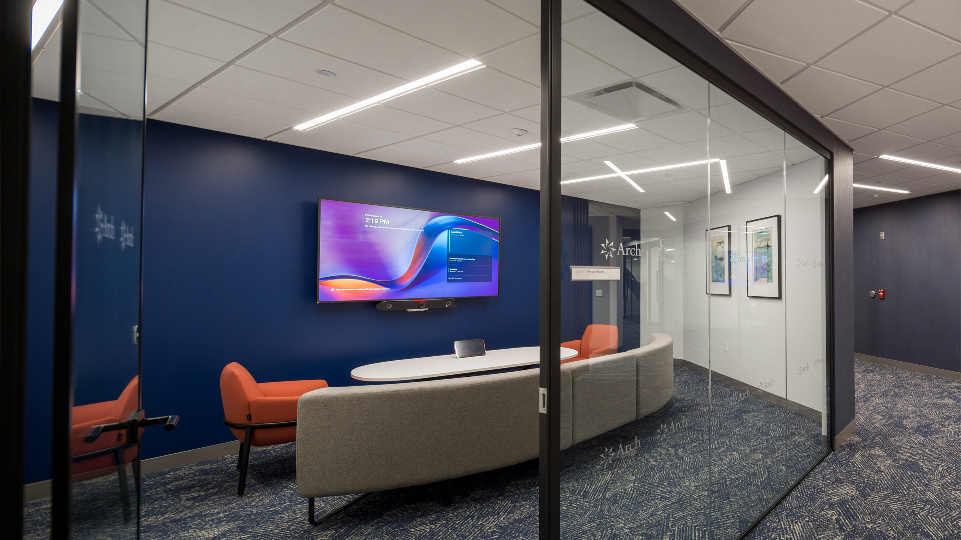 Flexible seating conference room with glass entry.