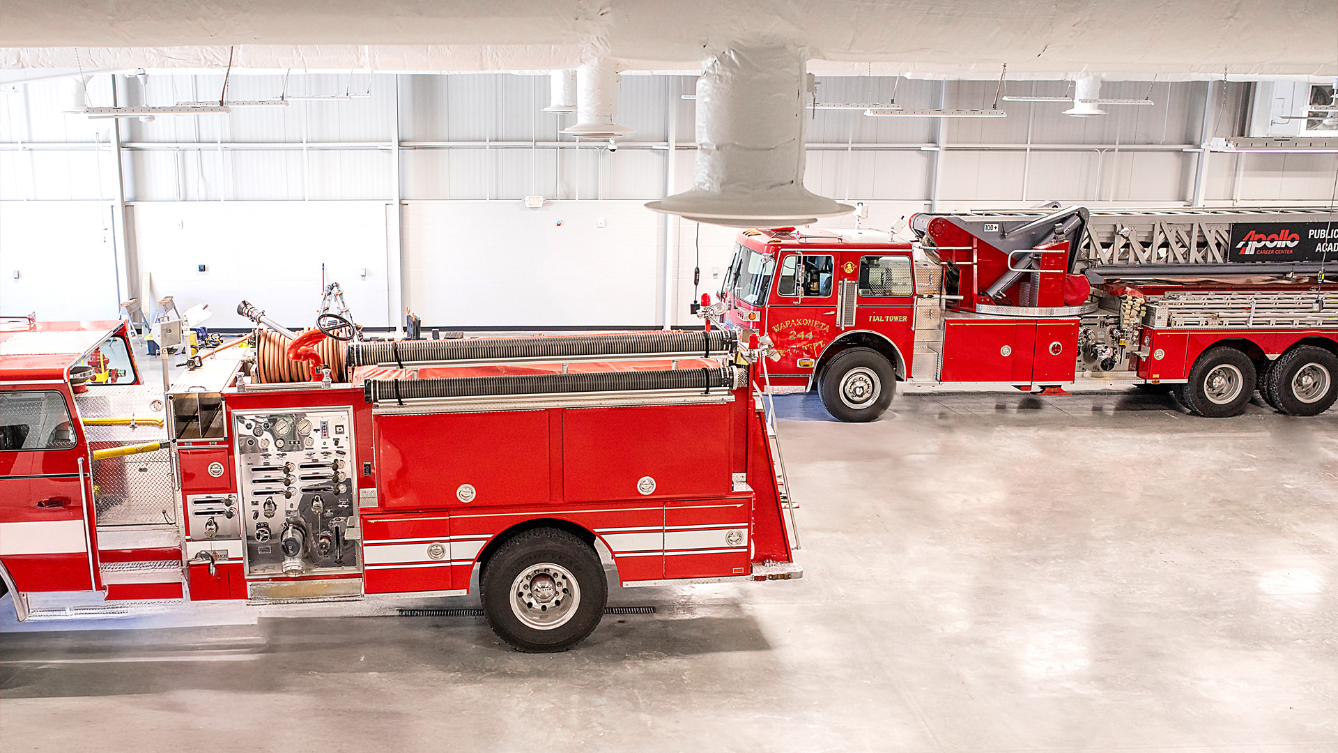 Technical classroom with industrial tone, housing fire trucks.