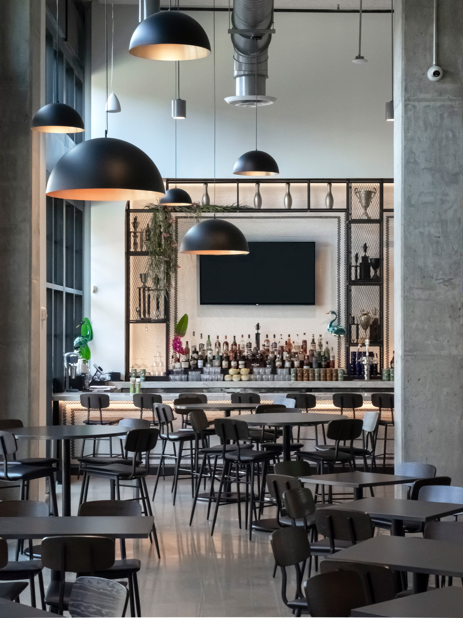 Industrial restaurant with formal and informal seating alongside a bold bar.