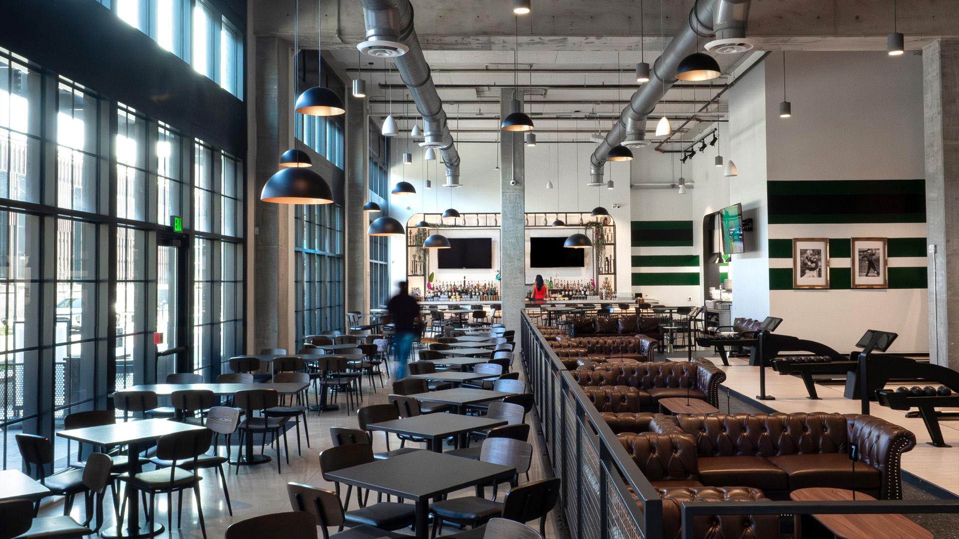 Industrial restaurant with formal and informal seating alongside a bold bar.