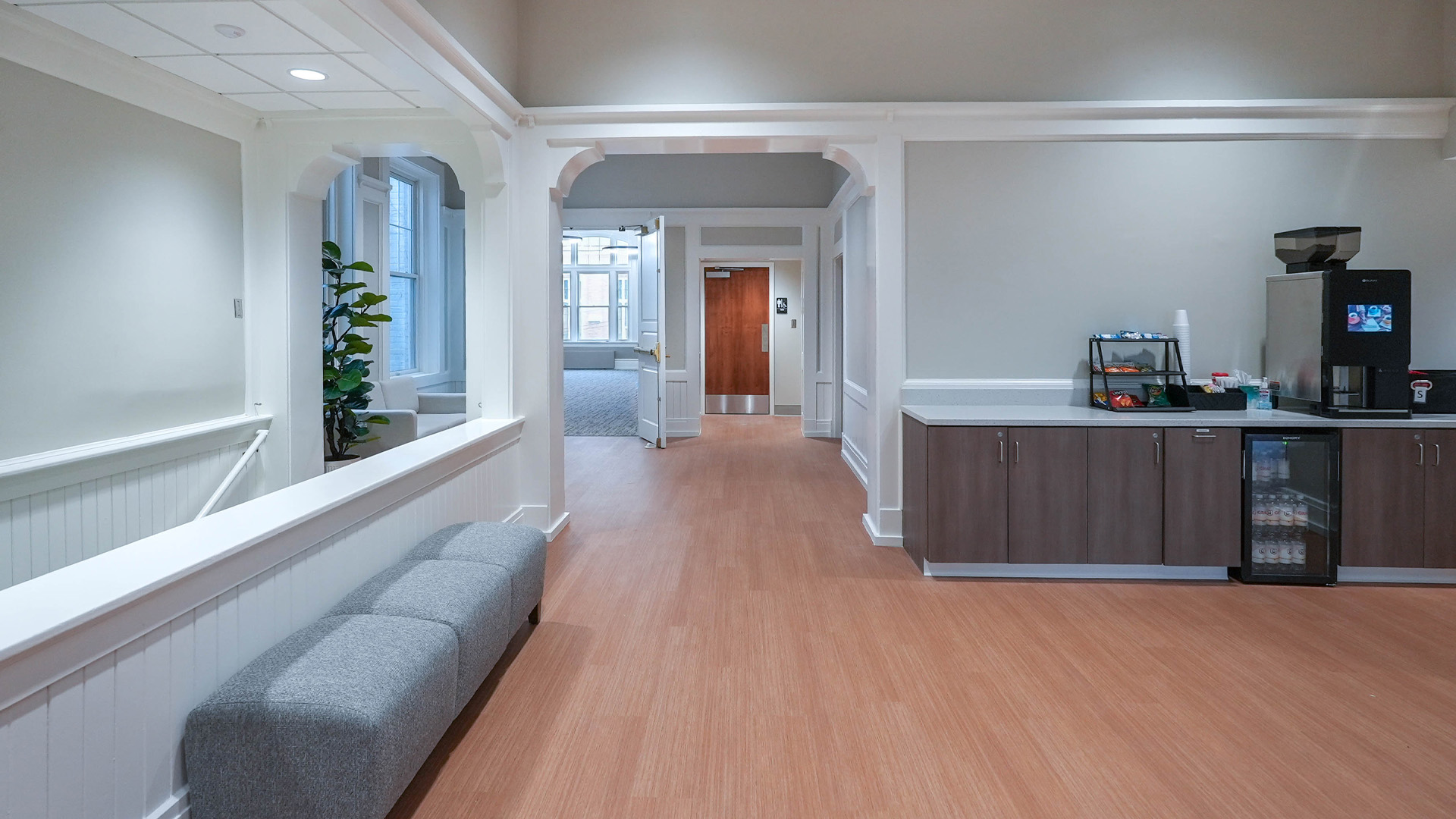 Cozy lobby area in Grace College's Westminster Hall with a kitchenette and wood flooring.