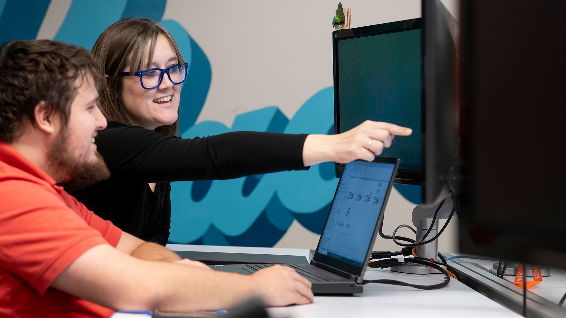 Two Coworkers Looking at Computer Screen