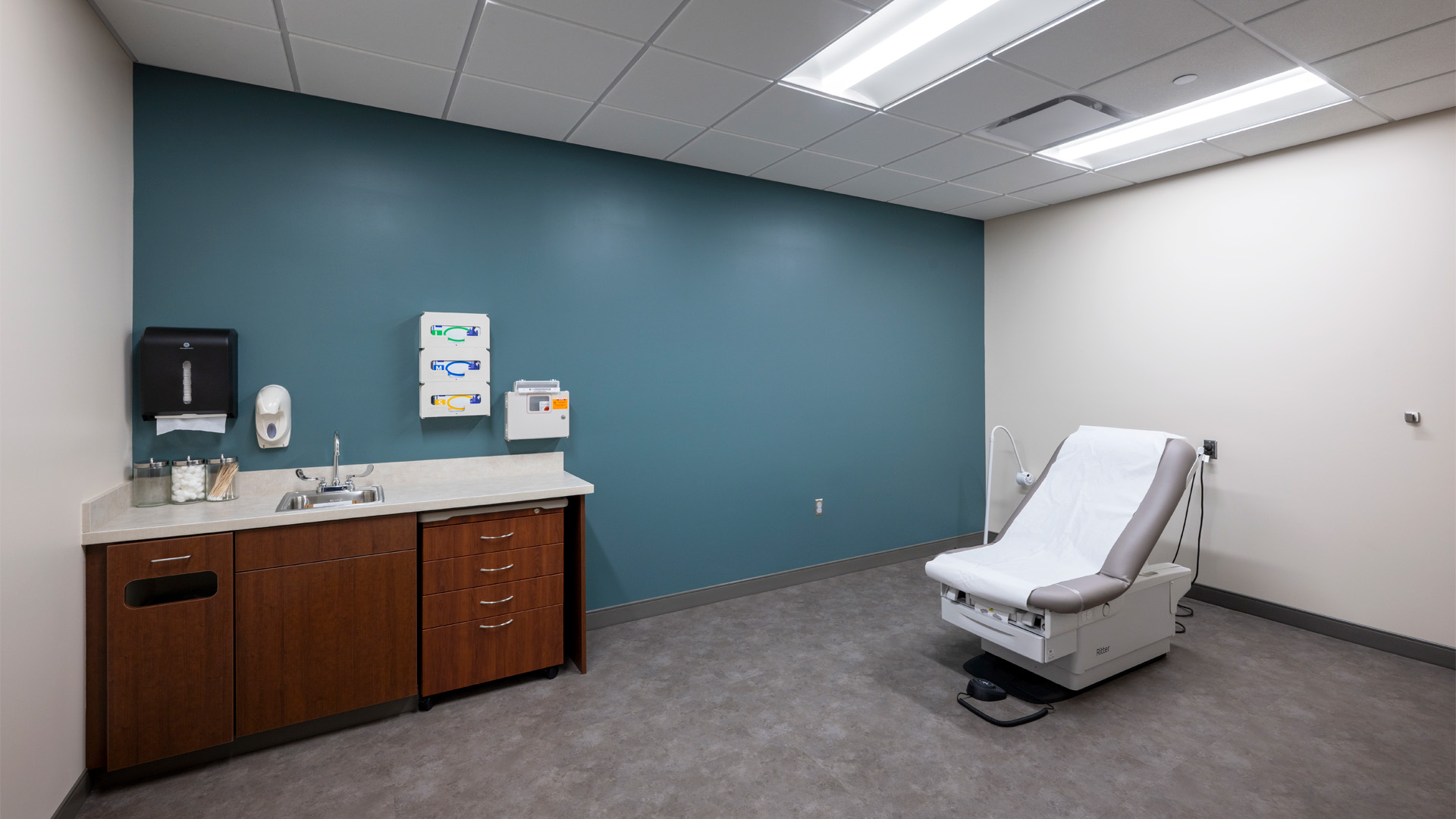 PPG Parkview Huntertown Clinic patient rooms with wood counters and blue walls.