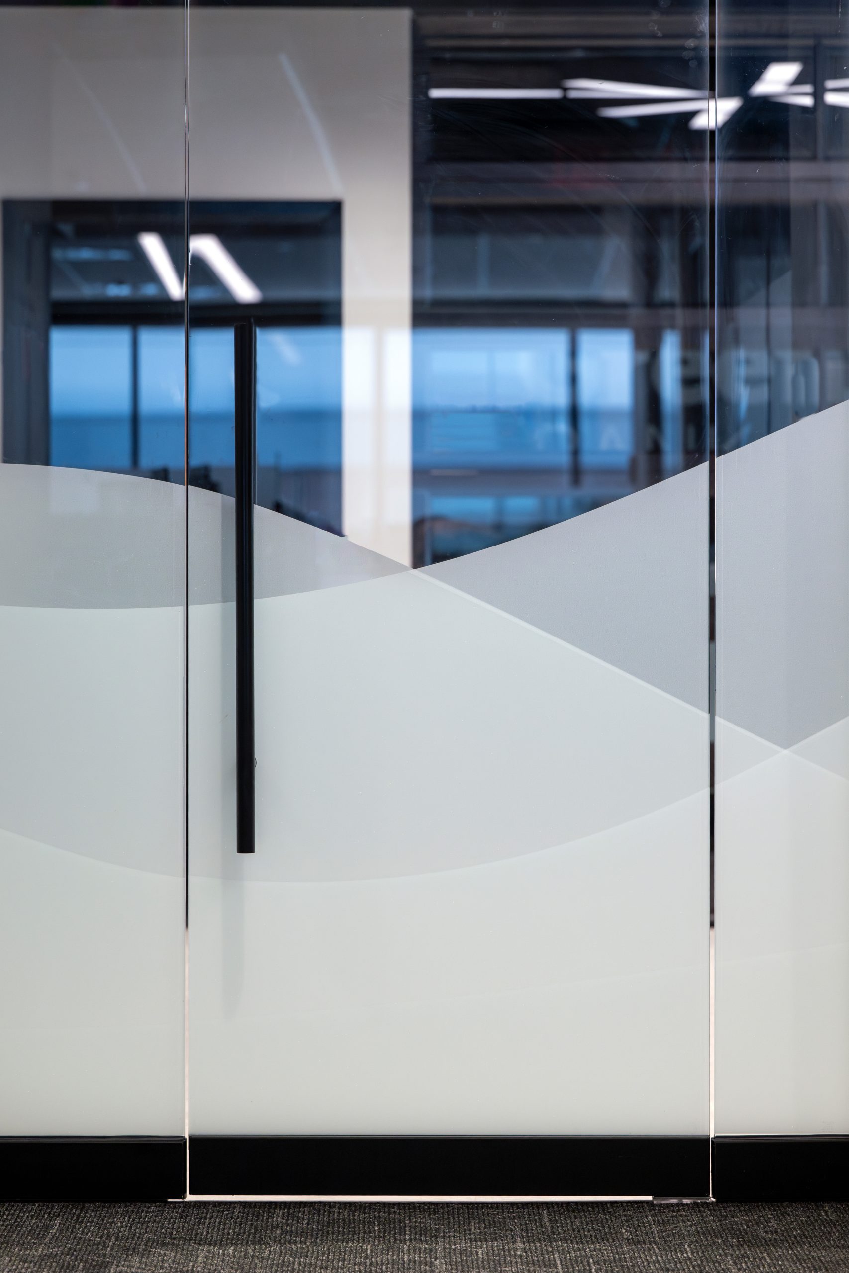 Greenway Bank interior door with graphic wave-like privacy film.