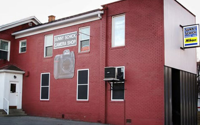 The old red brick building for the Sunny Schick Camera Shop.