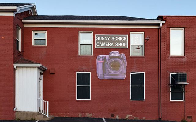 The old red brick building for the Sunny Schick Camera Shop.