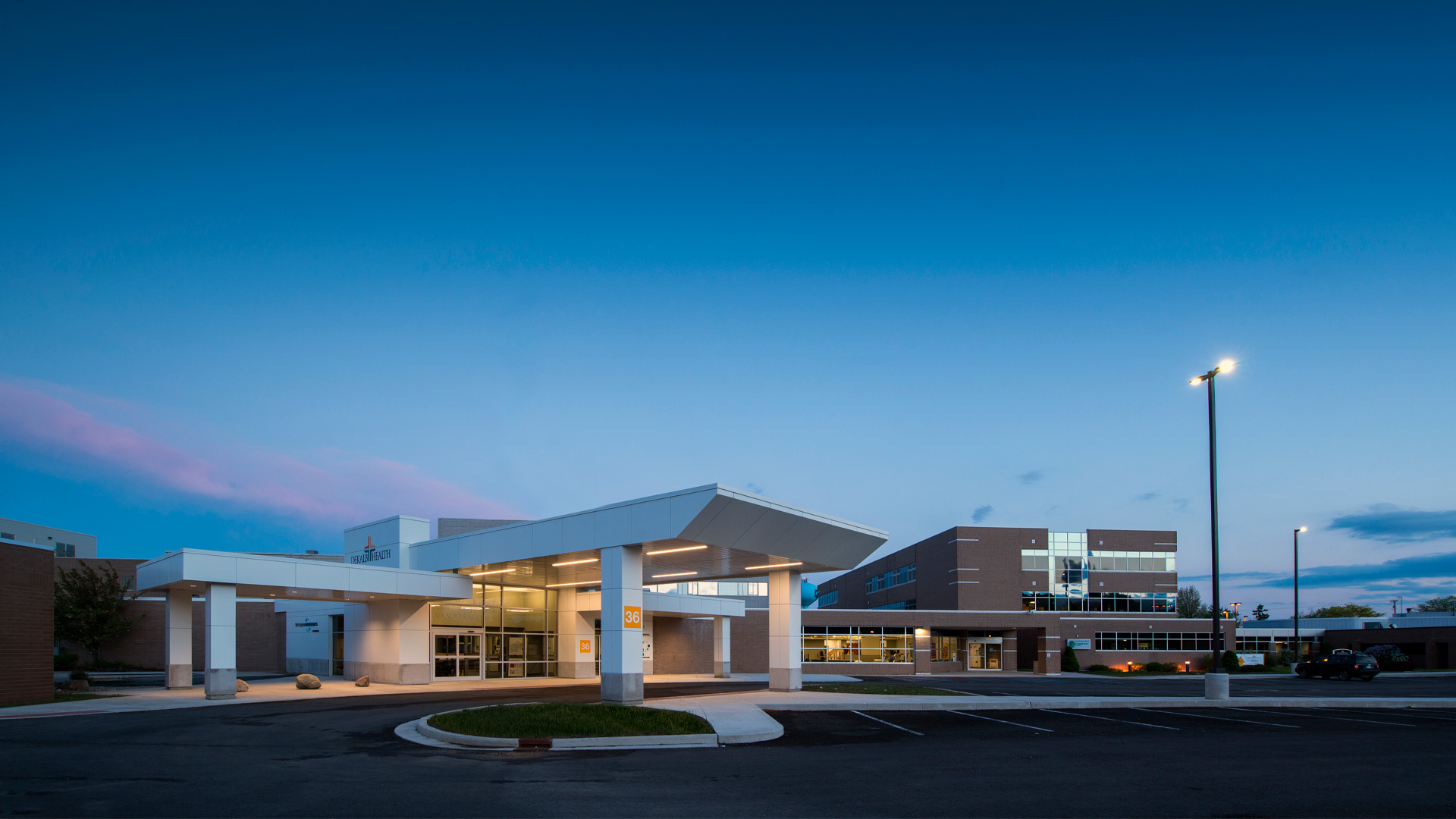 Exterior view of the DeKalb Health Outpatient Hospital at dusk.