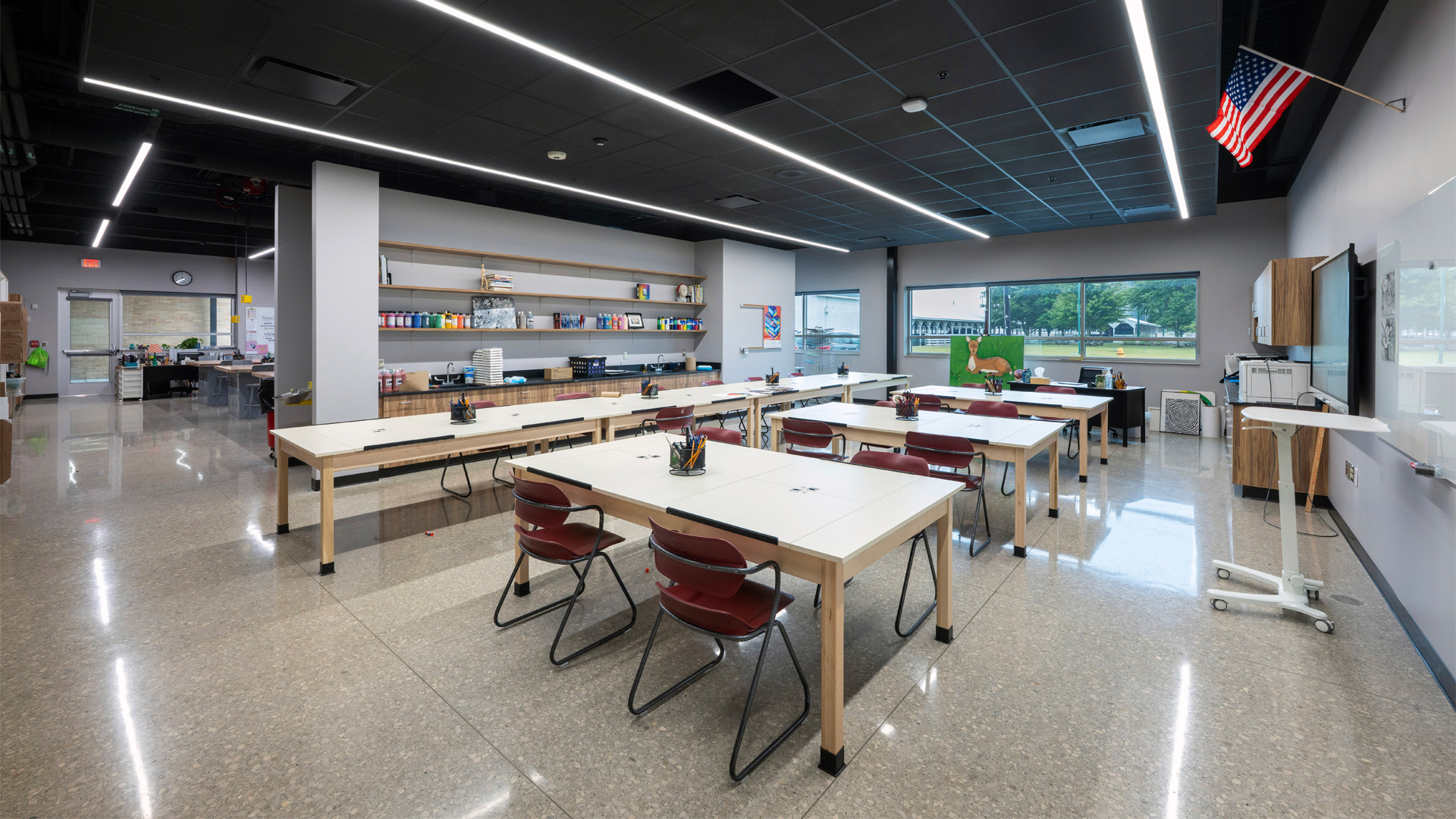 The Art Classroom at Adams Central in the 400 Wing Addition features large tables for collaboration and windows for natural light.