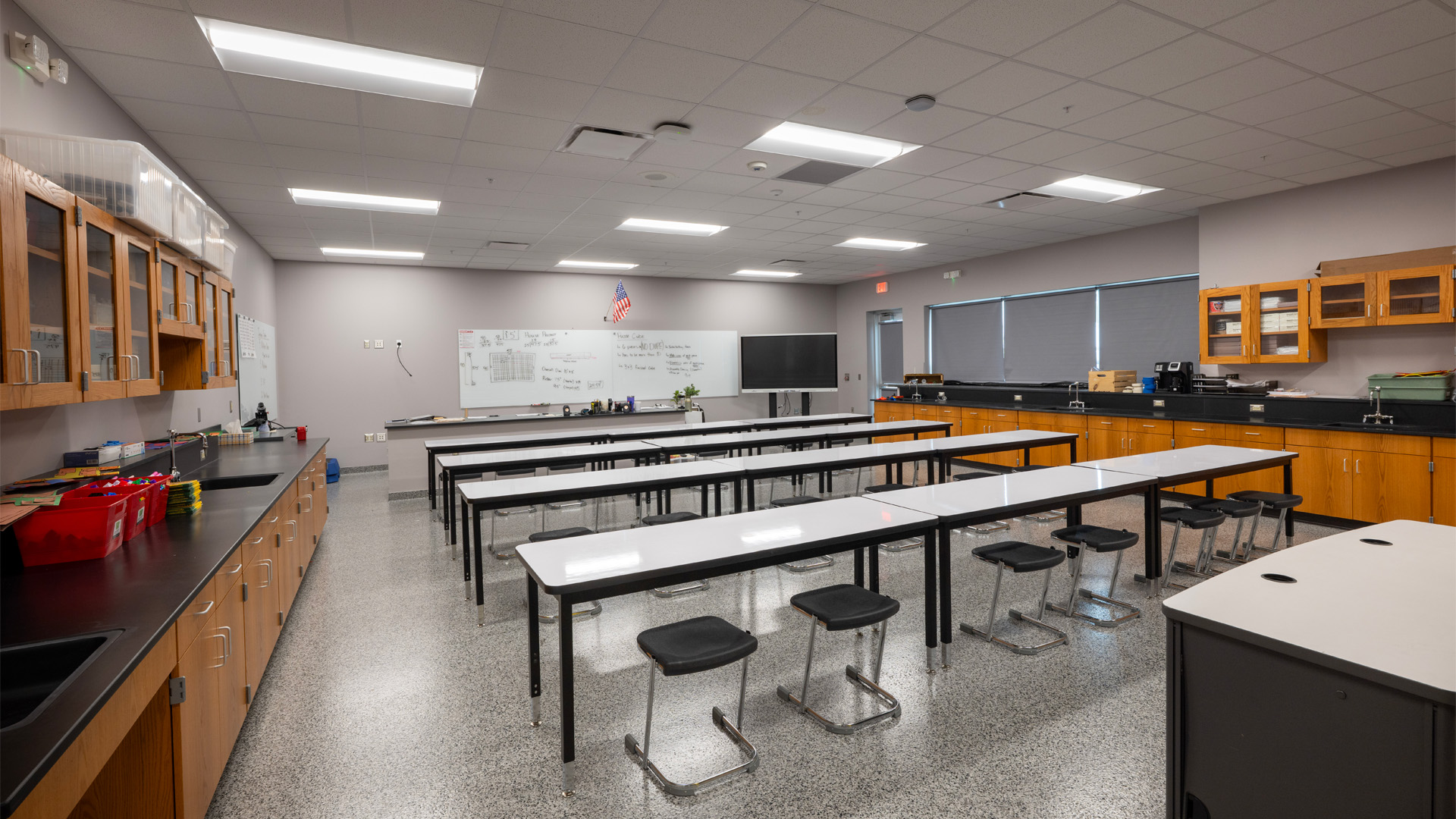 A classroom at Adams Central 400 Wing Addition features lots of storage space and lecture-style tables.