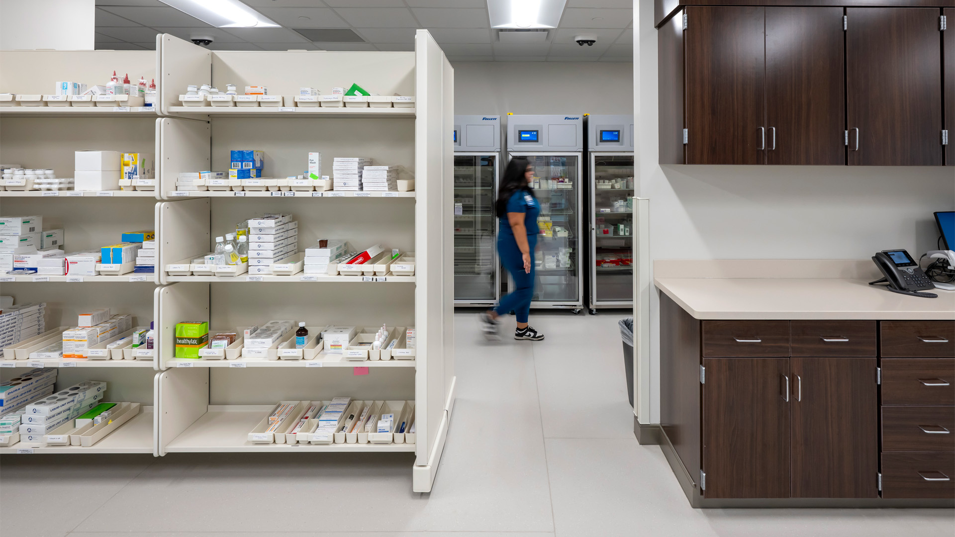 Women walking past medication storage in the OhioHealth Van Wert Hospital Pharmacy.