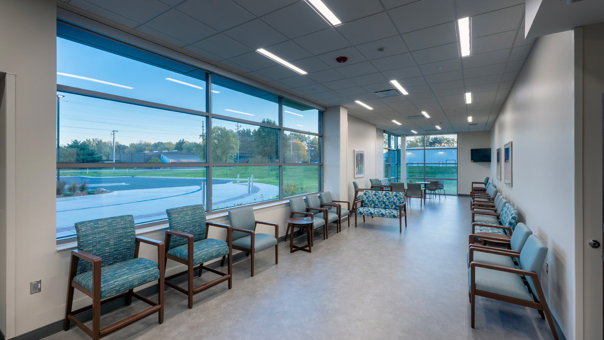 Waiting room with large windows and blue chairs at Parkview Physicians Group's Warsaw Clinic.