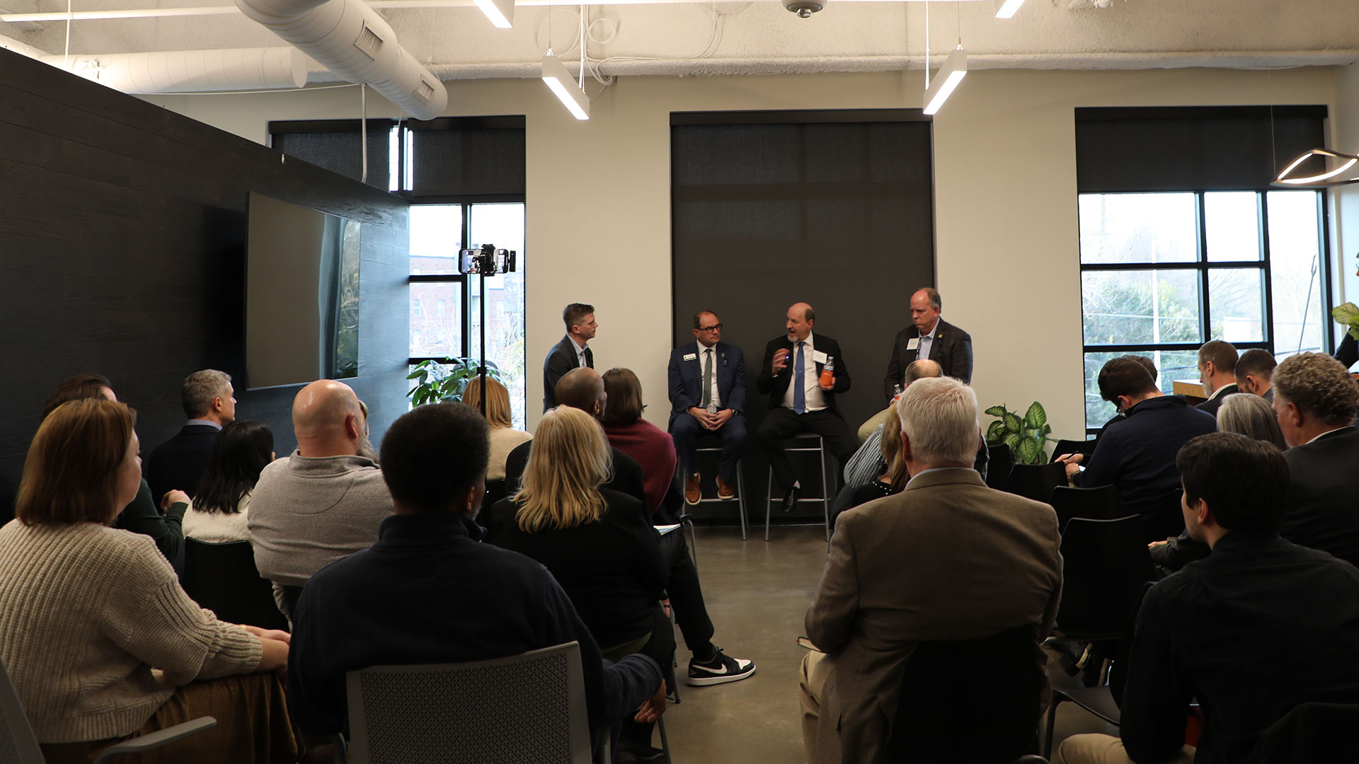 Full scale education panelists talking in front of crowd at the Design Collaborative's office in Charlotte.