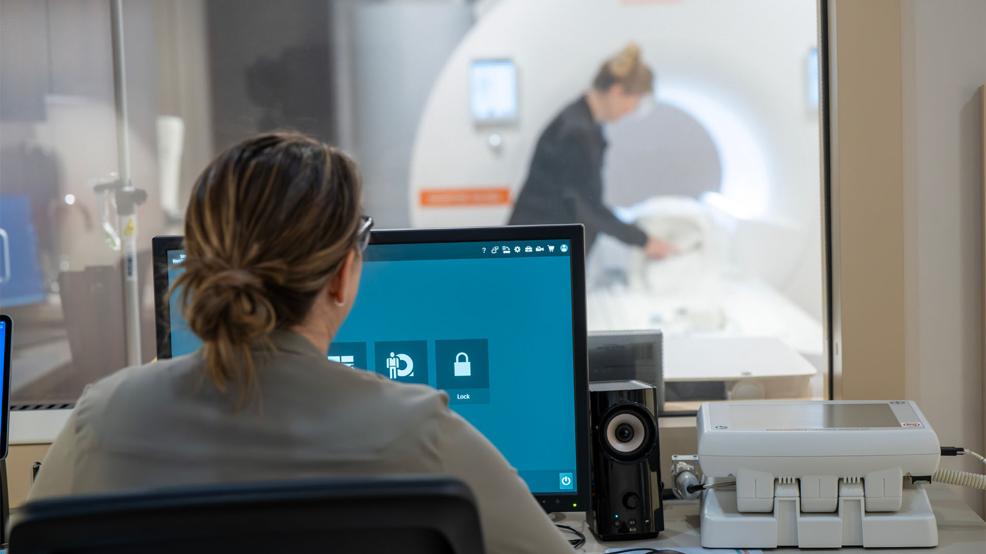 Nurses work at a computer and at an MRI machine in the Prefabricated MRI Unit at OhioHealth Hardin Hospital.