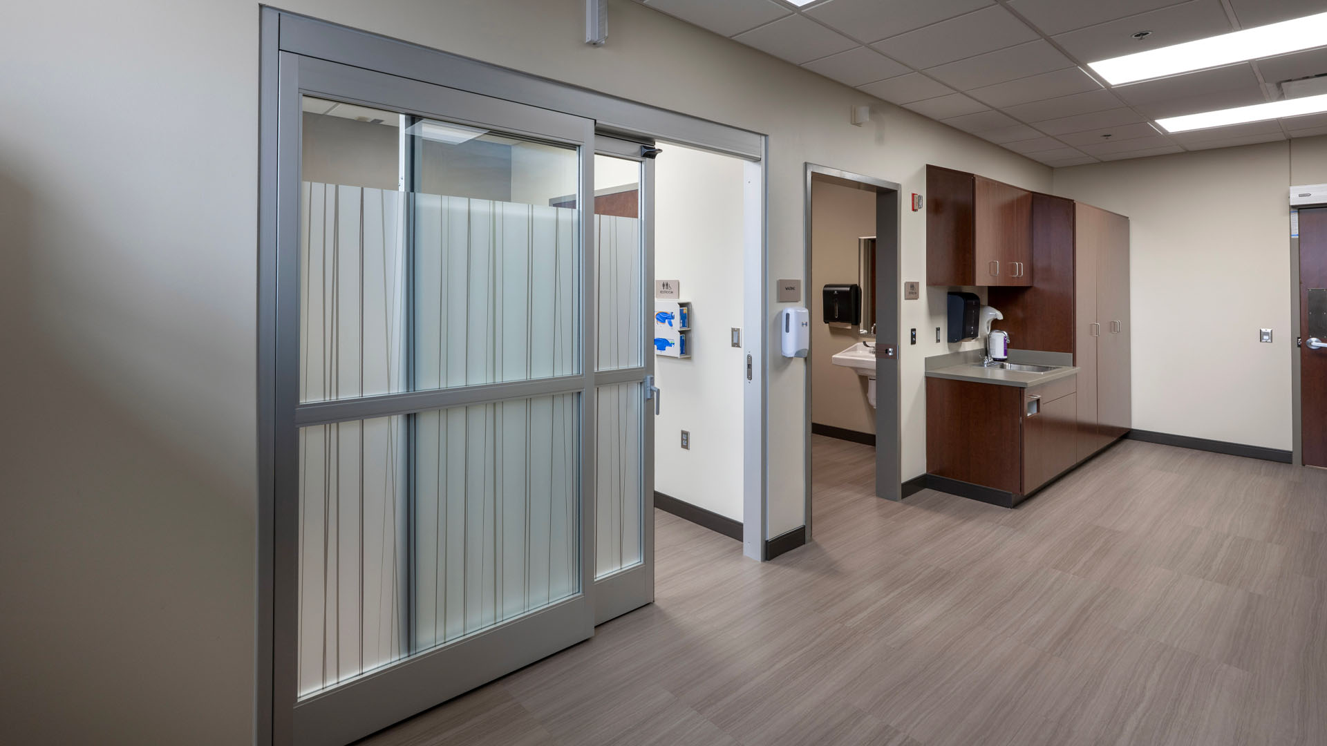 Hallway at Parkview Huntington Hospital with sliding glass doors with privacy glass.