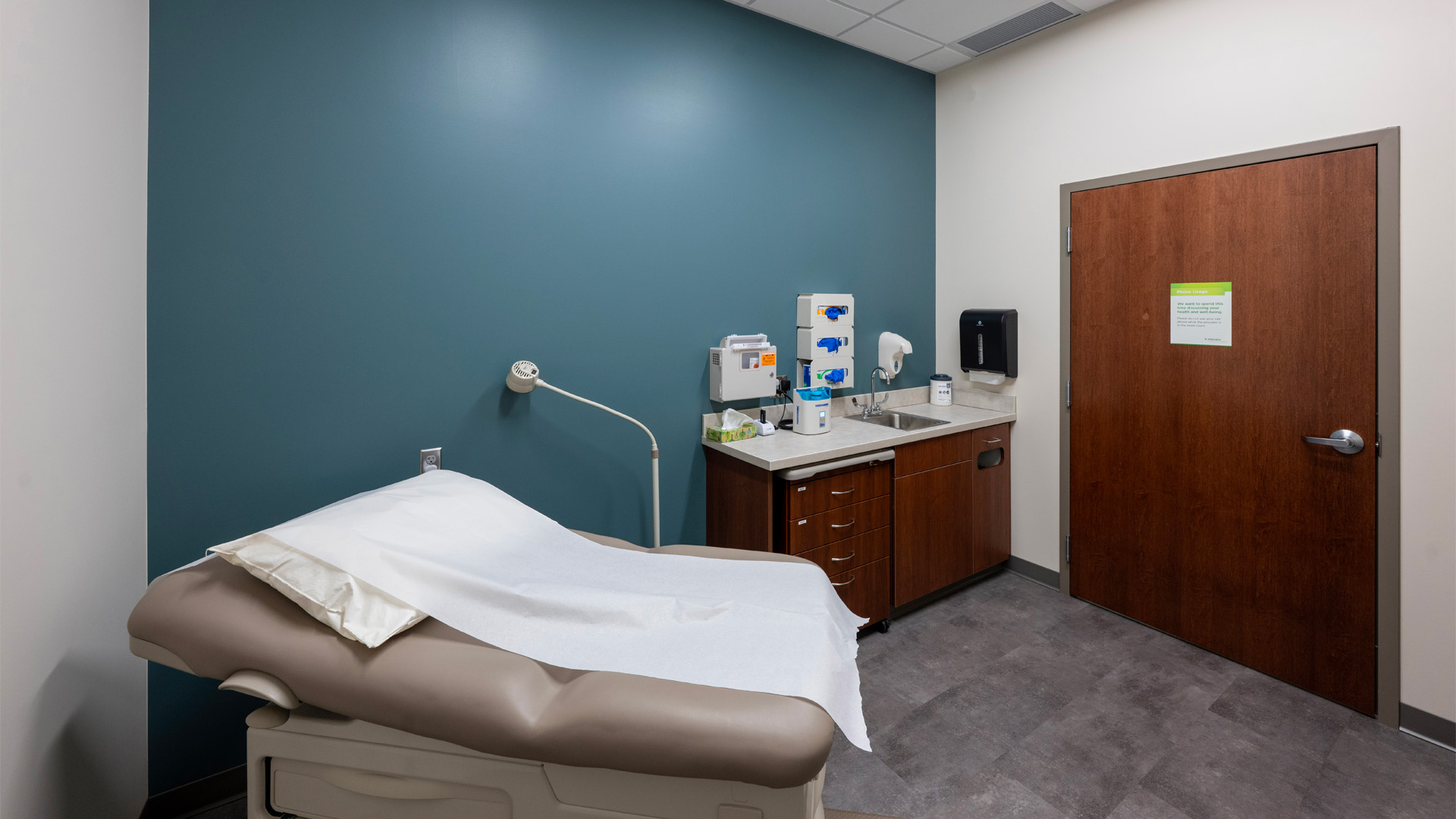 Patient room at Parkview Physicians Group Marion Clinic with calming blue wall and wide wood door.