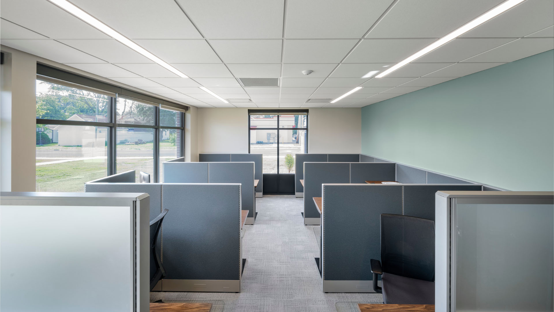 Shared office spaces at First Federal Bank Van Wert Branch with a soft blue wall and natural light.