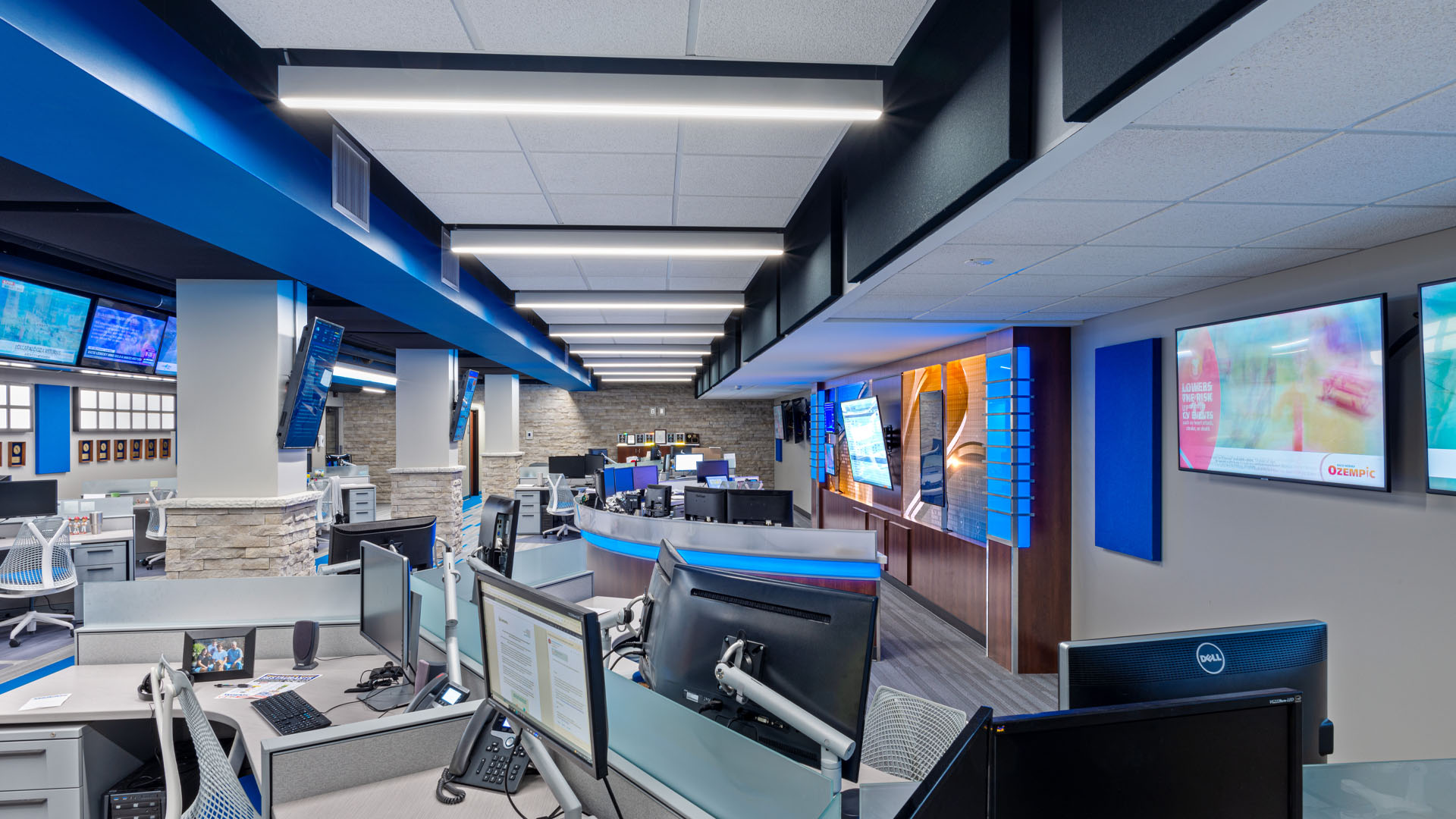 Quincy Broadcasting WGEM news studio with decorative blue accents, strong lines, and an open office layout.