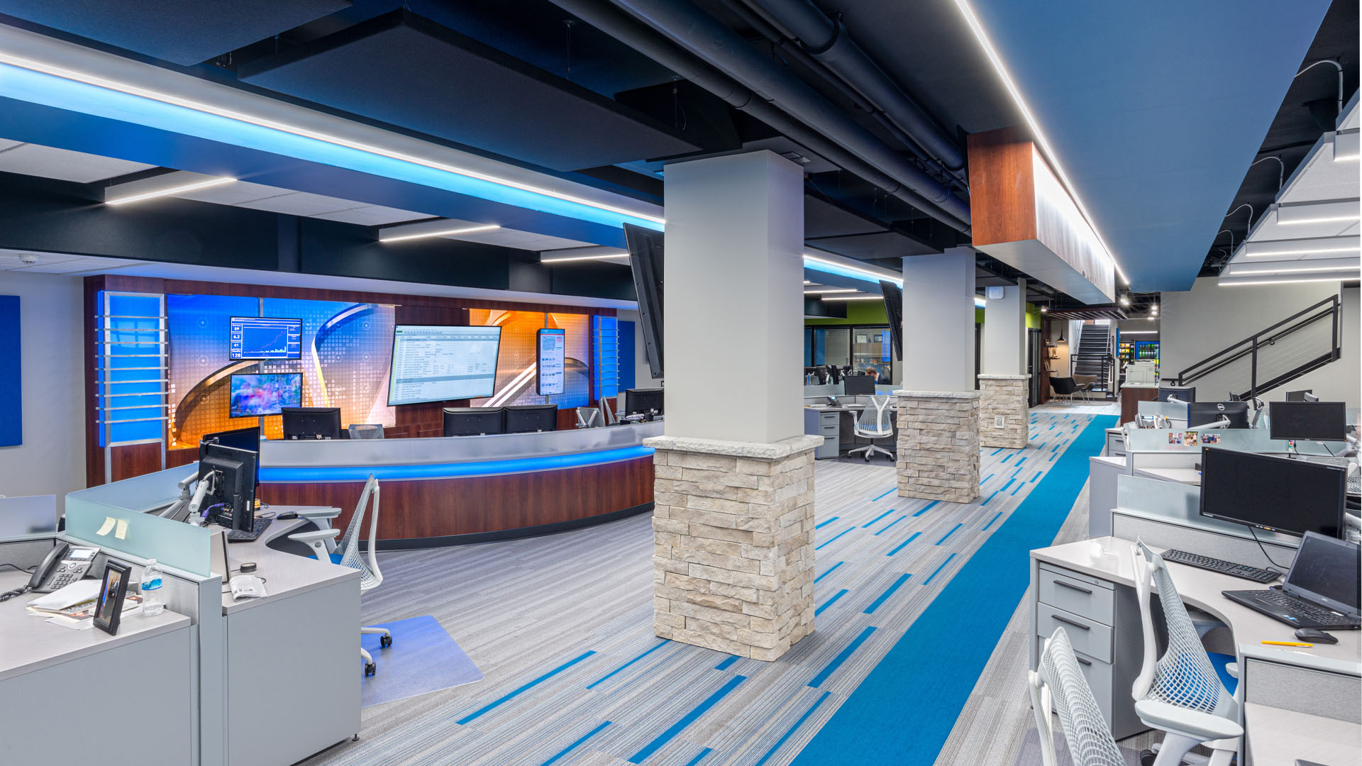 Quincy Broadcasting WGEM news studio with decorative blue accents, strong lines, and an open office layout.