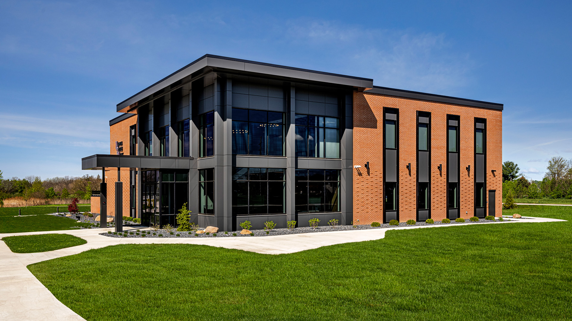 Side exterior view of the Bippus State Bank Operations Center in Huntington Indiana with a brick exterior, large windows, and modern features.