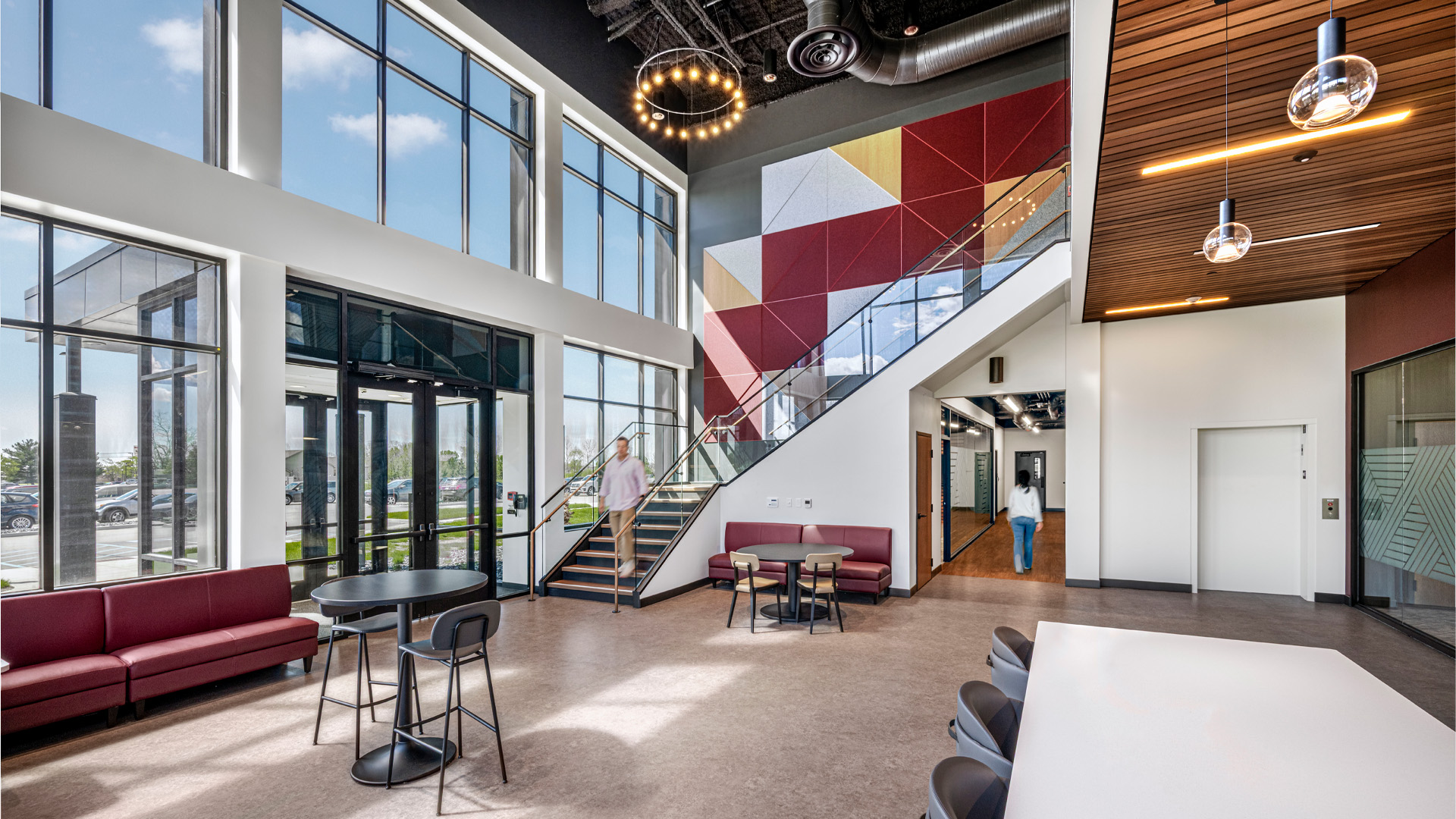 Bright and welcoming lobby in Bippus State Bank Operations Center with unique lighting and a open stairway.