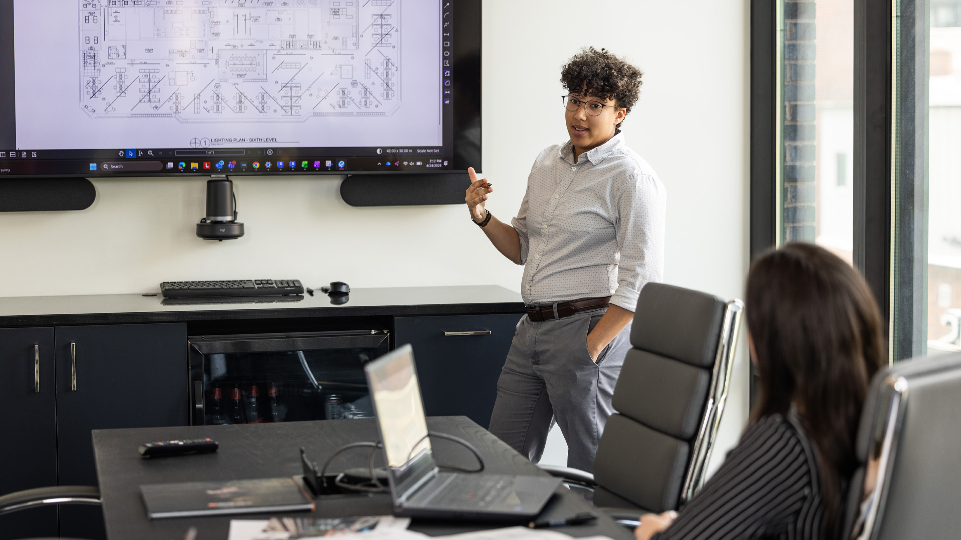 Design Collaborative employee in Charlotte North Carolina gives presentation on electrical building plans.
