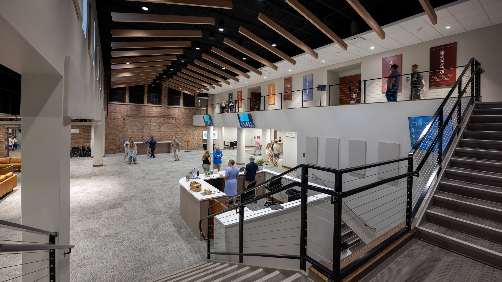 A large staircase leading to the lobby and gathering space at Headwaters Church in Fort Wayne Indiana.